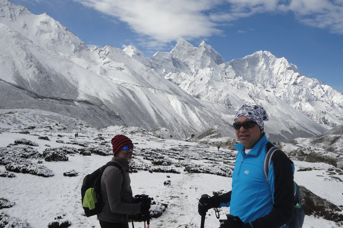Trekkers on the snowy trail to Everest Base Camp with Himalayan peaks behind